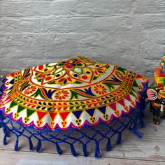 Indulge in luxury with our Handmade Indian Woolen Embroidery Pooja Thali Cover. Perfect for Pujas, weddings, and other special occasions, this multipurpose cover adds a touch of elegance to any event. Use it as a Prasad Thal, Puja Table Chowki, or simply as a beautiful decorative piece. Handcrafted with care, this cover is sure to impress. Package Information There are 3 variations (Pack Of 2 Red, Pack Of 2 Blue, Pack Of 4 2 Red & 2 Blue), you can select the one that best suits your needs. Material - Shining Silk Mix Fabric with woolen embroidery Generous Dimensions - These 17-inch diameter covers can be used in various ceremonial settings with a total dimension of 22 inches, these Thali covers provide ample coverage for a variety of uses. The spacious size ensures that your sacred items a Ceremonial Multicolor Traditional Wear With Dori Work, Multicolor Embroidered Fabric For Navratri And Traditional Ceremonies, Embroidered Choli For Puja Festival, Navratri Multicolor Embroidered Fabric For Traditional Ceremonies, Multicolor Embroidered Fabric For Traditional Ceremonies And Festivals, Ceremonial Embroidered Fabric For Festivals, Bohemian Embroidered Fabric For Diwali Puja, Embroidered Fabric For Puja And Festivals, Multicolor Embroidered Fabric For Diwali Puja