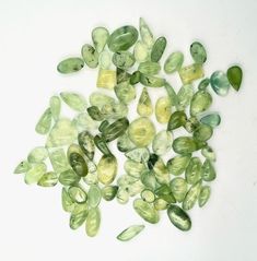 some green and yellow stones on a white surface