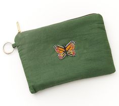 Part of Matr Boomie's Bala Mani Collection, this cosmetics pouch offers stylish and functional safekeeping of money, cards, makeup, keepsakes, and tech accessories -- to name a few! Artisans use traditional hand-beading techniques to create the modern butterfly, a symbol of transformation and a timeless, classic motif loved by many. From Matr Boomie. Compact Green Wallet For Travel, Compact Green Travel Wallet, Daily Use Pouch Clutch, Green Pouch Bag With Card Slots, Rectangular Wallets With Zipper Pouch, Everyday Rectangular Pouch, Portable Rectangular Cosmetic Bag For Everyday Use, Rectangular Wallets With Zipper Pouch For Everyday Use, Portable Handheld Cosmetic Bag For Travel