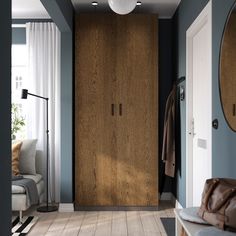 a living room with blue walls and wooden doors