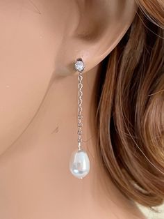 "Gorgeous, comfortable and chic, perfect for brides, bridesmaid or special someone in any occasion. These elegant earrings feature a lovely teardrop crystal ear, sterling silver post stud. Round cz stones dangle elegantly above a teardrop shape Swarovski pearl.  The pearl is available in your choice of white or ivory, light grey and dark grey. These measure approximately 1 3/4\"  inches long in total length. Shown on a life sized mannequin for reference.  These earrings comes in a gift jewelry b Elegant Long Drop Hypoallergenic Pearl Earrings, Elegant Hypoallergenic Long Drop Pearl Earrings, Elegant White Gold Bridal Drop Earrings, Elegant Long Drop Linear Earrings Hypoallergenic, Elegant Long Drop Hypoallergenic Linear Earrings, Elegant Silver Bridal Earrings With Pearl Charm, Elegant Silver Pearl Earrings For Party, Elegant Sterling Silver Pearl Earrings For Party, Elegant Pearl Linear Earrings For Party