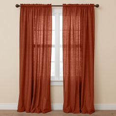 an orange curtain hanging in front of a window