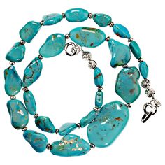 Elegant necklace of Sleeping Beauty Turquoise flat nuggets with silvery accents and a charming double heart clasp. The nuggets graduate from 11 to 32MM. This 19-inch necklace is the perfect Sleeping Beauty color from the world-famous Sleeping Beauty mine. MN2318 Turquoise Necklace With Gemstone Accents For Gift, Turquoise Pendant Necklace With Polished Beads, Gift Turquoise Emerald Necklace With Polished Beads, Nugget Necklace, Elegant Necklace, Sleeping Beauty Turquoise, Double Heart, Elegant Necklaces, Turquoise Necklace