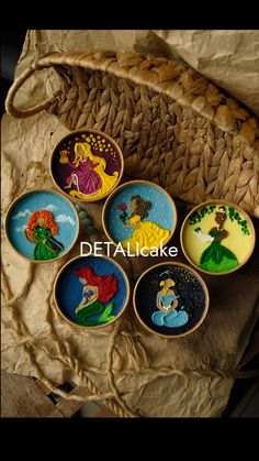 six hand painted dishes sitting on top of a woven cloth covered basket with the words, detalcake