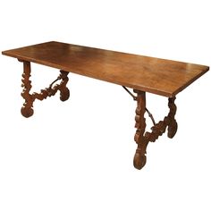 an old wooden table with wheels on the legs and one leg raised up to it's side