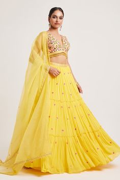 Yellow padded blouse featuring multi-color floral thread and embroidery with tassel detailing on the waistline. Paired with a can-can attached, sequin hand embroidered lehenga with pockets. Comes with a sheer embroidered dupatta. - Aza Fashions Multicolor Floral Embroidered Sleeveless Set, Multicolor Sleeveless Sets With Floral Embroidery, Bollywood Choli With Tassels, Festive Choli With Tassels, Summer Floral Embroidered Set For Reception, Summer Floral Embroidery Set For Reception, Spring Choli With Resham Embroidery In Georgette, Summer Lehenga With Cutdana For Reception, Summer Reception Lehenga With Cutdana Detail