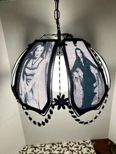 a chandelier with pictures of women hanging from it