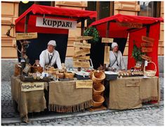 two people are selling bread at an outdoor market