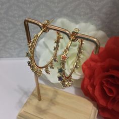 Very beautiful, elegant and high quality cz Diamanté cubic Zirconia hand crafted gold plated  multi colour star shape hoop earrings will add charm and charisma to your beautiful personality. Wear it with any of your formal or casual outfits and grab compliments all the way. Main Colour: gold Stone Colour: Multi Colour  Earrings Size: L x 4 cm cm / W x 4 cmcm Cubic Zirconia Hoop Earrings For Party, Gold Hoop Crystal Earrings For Party, Hoop Cubic Zirconia Earrings With Plating, Plated Cubic Zirconia Hoop Earrings, Cubic Zirconia Hoop Earrings With Plating, Hoop Earrings With Cubic Zirconia Plating, Cubic Zirconia Dangle Hoop Earrings, Sparkling Dangle Hoop Earrings With Cubic Zirconia, Sparkling Cubic Zirconia Dangle Hoop Earrings