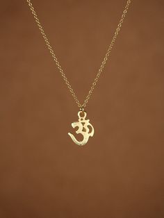 "Gold ohm necklace, yoga necklace, pranava, omkara, zen necklace, silver ohm necklace A gold vermeil ohm symbol hangs from a 16 inch 14k gold vermeil chain. Please feel free to select a different length chain if you prefer! Ohm Measurement: 12mm Ohm is a holy meditation symbol of Hinduism, Buddhism, and Jainism with a profusion of esoteric and exoteric meanings. In modern usage Om means the Word, the \"parnava,\" the eternal. Need a pop of color? You can add a little tourmaline drop if you like! Symbolic Necklaces For Meditation And Festivals, Symbolic Pendant Charm Necklaces For Meditation, Dainty Pendant Charm Necklaces For Meditation, Holistic Pendant Charm Necklaces For Meditation, Ohm Necklace, Indian Wedding Rings, Ma Tattoo, Ohm Symbol, Indian Diamond Jewellery