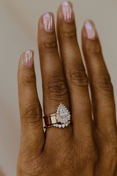 a woman's hand with two rings on it and one ring in the middle