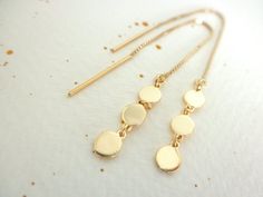 This earrings are very dainty and light to wear.Three teeny tiny gold vermeil discs  charms  connected to a  14K gold-filled box chain ear threader.Discs are 4mm each. Total length is about 4 1/2".--------------------Matching ring:https://www.etsy.com/listing/263451614/disc-chain-double-ring-gold-vermeilMatching necklace:https://www.etsy.com/listing/265619003/mini-gold-disc-necklace-multi-disc-14k--------------------Available on SILVER:https://www.etsy.com/listing/269517816/disc-ear-thread-earri Gold Nickel-free Threader Earrings, Nickel-free 14k Gold-filled Gold Threader Earrings, Gold Round Threader Earrings For Everyday, Gold Threader Earrings With Delicate Chain, Dainty Gold Hypoallergenic Threader Earrings, Dainty Yellow Gold Threader Earrings, Delicate Gold Hypoallergenic Threader Earrings, Delicate Adjustable Gold Threader Earrings, Gold Coin Earrings