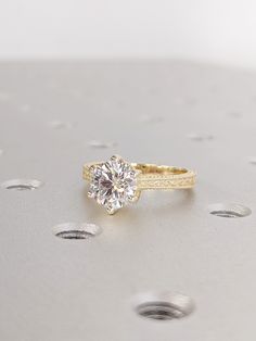 a diamond ring sitting on top of a table