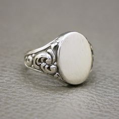 This antique/vintage men's signet ring is handcrafted in 830 silver, featuring beautiful Biedermeier foliage ornamentation on the shoulders. A fine example of Victorian-style European jewelry from the 1930s-1940s, or possibly earlier. The ring face has a brushed finish and is blank, allowing you to personalize it with your own monogram or engraving (please note that we do not offer this service). The ring will be shipped in a gift box, ready for gifting or adding to your collection. A classic an Vintage Signet Ring, The Ring Face, European Jewelry, Signet Ring Men, Signet Rings, Silver Signet Ring, Mid Century Jewelry, Men Vintage, Silver Man