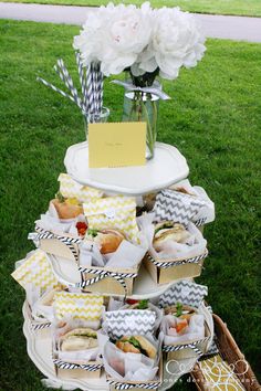 a table topped with lots of candy and candies on top of a grass covered field