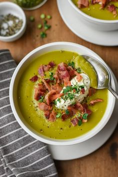 two bowls filled with soup and topped with bacon