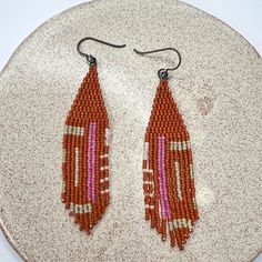 - handwoven with delica seed beads size 11/0 - width : .75 inch - drop length from the top to the last bead on the longest fringe is 3.5 inches - handmade in new york Artisan Adjustable Beaded Earrings With Tiny Beads, Brown Teardrop Beaded Earrings With Colorful Beads, Brown Dangle Beaded Earrings With Tiny Beads, Brown Teardrop Beaded Earrings, Beach Heishi Beaded Earrings, Beach Beaded Earrings With Colorful Beads, Colorful Beaded Brown Earrings For Beach, Brown Beaded Earrings For The Beach, Brown Beaded Earrings For Beach