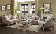 a living room with couches, chairs and a coffee table in front of a fireplace