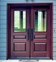 the front door is brown and has two sidelights on each side with glass panels