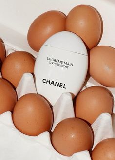 a bunch of eggs in a carton with the label chanel written on it