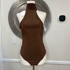 Wayf Brown Turtle Neck Sleeveless Body Suit- Size M Length: 30” Underarm To Underarm: 15” Materials: 96% Polyester, 4% Spandex Fitted Halter Neck Tank Top For Night Out, Chic Fitted Cami Vest, Brown Stretch Sleeveless Tank Top, Stretch Sleeveless Halter Top, Brown Fitted Cami Tank Top, Fitted Brown Sleeveless Tank Top, Fitted Sleeveless Tank Top, Chic Fitted Tank Vest, Chic Fitted Sleeveless Vest