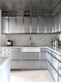 a kitchen with stainless steel cabinets and counter tops