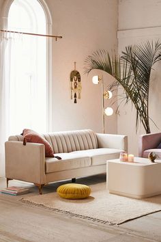 a living room with two couches and a coffee table in front of a window