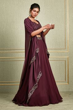 Plum layered cape with floral embroidered motifs. Paired with floral embroidered waistband lehenga and embroidered blouse.
Component: 3
Embroidered
Neckline: Leaf 
Sleeve Length: Elbow
Fabric: Paper silk, Tussar Silk, Georgette
Color: Maroon
Layered cape - Aza Fashions Evening Cape Sets Made Of Georgette, Elegant Palazzo Set With Cape For Festive Occasions, Elegant Cape Palazzo Set For Festive Occasions, Elegant Anarkali Set With Resham Embroidery And Cape Sleeves, Designer Cape Dress With Dupatta, Evening Palazzo Set With Cape Sleeves And Dupatta, Elegant Cape Sets For Reception, Georgette Cape Sets, Designer Georgette Cape Set