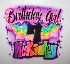 a birthday girl shirt with the number one on it and rainbow paint splatters