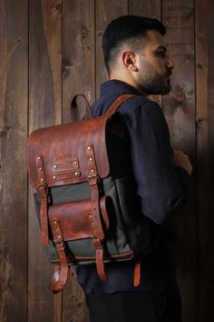 HIKI BAG*LAPTOP BACKPACK*HİKİNG BAG*BİRTHDAY GİFT*BOYFRIEND GİFT * Made of waterproof fabric and genuine leather. * Size: 17,3 H x 10,6 L x 4,3  W / 44x 27x 11cm * There are special drinkers for thermos and flask on the side of the bag. * The leather cover gives the bag an elegant look and increases its durability. *The canvas fabric, which is waxed with beeswax and paraffin to make it waterproof, creates patterns when folded and offers a rich look. * You can use and personalize this bag with co Casual Leather Rectangular Backpack For School, Casual Rectangular Leather Backpack For School, Black Leather Backpack For Outdoor Activities, Vintage Rectangular Backpack With Pockets, Casual Black Leather Backpack For Outdoor Activities, Casual Black Leather Backpack For Outdoor, Vintage Black Satchel Backpack, Black Vintage Satchel Backpack, Travel Backpack With Pockets In Waxed Canvas