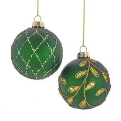 two green ornaments hanging from gold chains on a white background, each with an ornament in the shape of a leaf