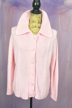 "Pre Loved Great Condition No Stains or Snags Vintage 70s Pink Knit Sweater/Cardigan 6 Big Button Front Closure Warm and Cozy for Winter Material: Acrylic Approx..Size Medium Large Measurements are taken laid flat. Check the Measurements Below Shoulder to Shoulder: 16 1/2\"- 17\" Armpit to Armpit: 21 1/2\" Sleeves: Approx. 25\" Waist: 41\" Length: 24 1/2\" Shipping from 3-5 Days No Returns or Exchanges If you have any questions..Please send me a Message. Thank you for Visiting.." Vintage Knit Sweater Coat, Vintage Knitted Long Sleeve Sweater Coat, Vintage Long Sleeve Soft Knit Sweater, Vintage Knit Sweater Coat With Long Sleeves, Vintage Knitted Sweater Coat With Long Sleeves, Vintage Long-sleeved Knit Cardigan, Vintage Long Sleeve Knit Cardigan, Vintage Knit Outerwear With Buttons, Vintage Knit Outerwear With Button Closure