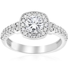 a white gold ring with diamonds on the sides and a halo setting in the center