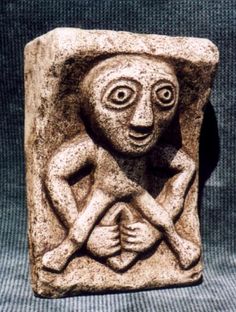 a stone block with an image of a man holding a baby on it's chest