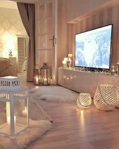 a living room filled with furniture and a flat screen tv mounted to the side of a wall