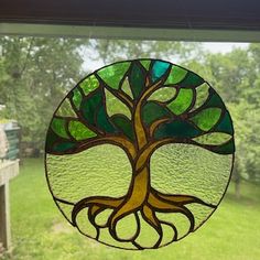 a stained glass window with a tree on it