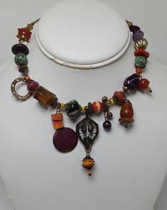 This great signed necklace by Treska is incredibly unique both in quality and appeal. It has tiered pendanta and great beadwork. It measures about 16" in total length with the center pendant measuring about 2 1/2" down. The beading covers about 9 1/2" along the necklace. It has no apparent damages or repairs Vintage Adjustable Jewelry With Dangling Beads, Bohemian Metal Jewelry With Large Beads, Metal Necklace With Large Beads For Gift, Vintage Pendant Beaded Necklaces With Colorful Beads, Vintage Beaded Round Pendant Necklace, Vintage Beaded Pendant Necklaces With Colorful Beads, Festival Metal Jewelry With Large Beads, Vintage Adjustable Beaded Necklace With Round Pendant, Beaded Metal Round Pendant Jewelry