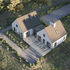 an aerial view of a two story house with metal roofing and brown shingles