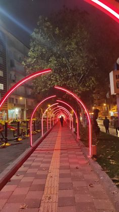 the walkway is lit up with red lights