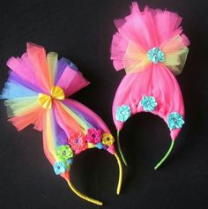 there are two hats that have flowers on them and tulle hair accessories in the shape of bows