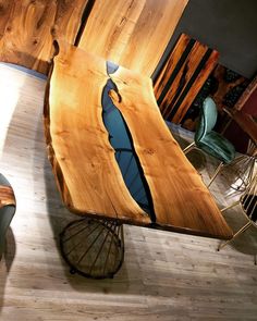 a table made out of wood sitting on top of a hard wood floor next to a chair