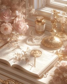 an open book sitting on top of a table next to candles and flowers in front of a window