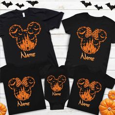 three shirts with mickey mouse heads on them, and pumpkins in the foreground