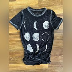 Size Xs Women’s Tee With The Moon Phases On The Front. Very Light Material. Back Is Longer Than The Front And The Material Is Semi See Through. I’ve Had The Tee With The Knot In The Front! Excellent Condition! Black Summer Top With Moon Print, Relaxed Fit Moon Print Short Sleeve Tops, Black Moon Print Crew Neck Top, Black Crew Neck Top With Moon Print, Black Short Sleeve Top With Moon Print, Trendy Black Top With Moon Print, Trendy Relaxed Fit Top With Moon Print, Fitted Moon Print Crew Neck Top, Summer Short Sleeve Top With Moon Print