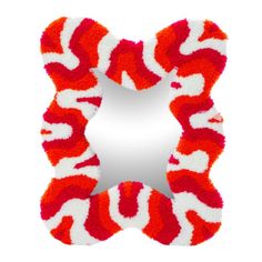 a red and white animal print shaped mirror