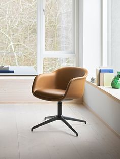 an office chair sitting in front of a window