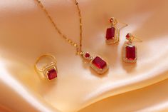 Introducing our exquisite Luxury Red Zircon Jewelry Set, a dazzling collection of meticulously crafted pieces designed to add a touch of elegance and sophistication to your style. This set includes a stunning Gemstone Pendant, Sapphire Ring, Necklace, and Earrings, making it the perfect choice for brides, engagements, or any special occasion. Features: 1. Red Zircon Gemstone Pendant: A brilliant red zircon gemstone is the focal point of this exquisite pendant. Crafted with precision and care, the pendant showcases the deep, rich hue of the red zircon. The pendant is elegantly set in a high-quality metal setting, adding to its allure. 2. Red Zircon Sapphire Ring: This dazzling ring features a radiant red zircon gemstone, accented by shimmering sapphire stones. The unique design and meticulo Ruby Jewelry Sets For Gifts, Round Ruby Jewelry Sets For Gifts, Ruby Jewelry With Matching Earrings For Gift, Ruby Jewelry Set With Matching Earrings As A Gift, Ruby Jewelry With Matching Earrings As A Gift, Fine Jewelry Ruby Gift, Red Cubic Zirconia Jewelry Sets, Red Ruby Jewelry Sets As Gift, Red Ruby Jewelry Sets For Gifts