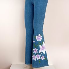 "Hand painted Bell Bottomed Jeans by Lost Ginger Every piece is painted by hand, with its own special, unique design and no two items are exactly the same.  Each design is painted with indelible water resistant textile paints. Flowers have been used over centuries to symbolize meanings and convey messages. In nature, each flower has its own special meaning whether expressed as a bouquet or an art form. Offer a gift with a hand painted flower to say with grace, \"I appreciate you. Thank you.\" For perfect fit you can see the detailed dimensions below: Size: US: 8 Waist: 29 inches / 74 cm The jean has strings on the waist so you can adjust it. All dimensions measured in unstretched state. Machine wash at low temperatures (up to 30 C), do not iron the image, do not machine dry, do not bleach. Pink Flare Denim Bottoms, Pink Flare Denim Jeans, Hand Painted Denim Bottoms For Summer, Artistic Hand Painted Bottoms For Summer, Casual Hand Painted Cotton Bottoms, Hand Painted Blue Jeans For Spring, Artistic Hand Painted Bottoms For Spring, Hand Painted Cotton Summer Bottoms, Hand Painted Cotton Bottoms For Summer