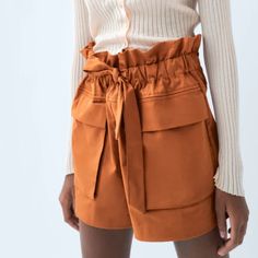 High-Waist Bermuda Shorts Featuring Front Patch Pockets With Flaps. Tied Belt In The Same Fabric. Beautiful Burnt Orange Color. I Wish They Fit Me! Too Large. Materials Outer Shell 97% Cotton 3% Elastane Paperbag Waist Bottoms With Built-in Shorts For Day Out, Chic Paperbag Waist Bottoms With Tie, Trendy Bottoms With Paperbag Waist And Pockets, Brown Paperbag Waist Bottoms For Work, Chic Paperbag Waist Bottoms For Day Out, Chic Paperbag Waist Bottoms For Fall, Fall Bottoms With Paperbag Waist And Belt Loops, Fall Bottoms With Belt Loops And Paperbag Waist, Fall Bottoms With Tie Waist For Day Out