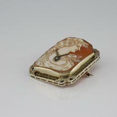 Antique 14K White Gold Rectangular Pin Pendant Deco, shell cameo with round diamond necklace, woman looking right, 1 1/2 x 1 1/4 inch, filigree frame with applied leaf corners, Circa 1925, locking clasp, hinged bail, 11 grams. Stock # BB266CamPP15 This listing contains photographs of the actual item you will receive. Our items are in excellent condition with little or no signs of wear and many are one of a kind pre-owned estate finds. Please look closely at the pictures in this listing as they a Gold Intaglio Jewelry For Evening, Elegant Evening Jewelry With Cameo Detail, Antique Formal Jewelry With Cabochon, Antique Medallion Jewelry For Evening, Elegant Cameo Jewelry For Formal Occasions, Antique Intaglio Jewelry For Formal Occasions, Gold Cameo Jewelry For Evening, Formal Yellow Gold Cameo Jewelry, Antique Cameo Yellow Gold Jewelry